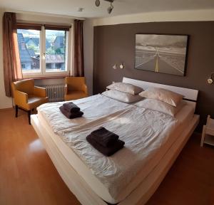 a bedroom with a large bed with two towels on it at Roastineer Hotel in Battenberg