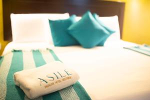 Postel nebo postele na pokoji v ubytování Asilé Hotel Boutique