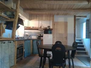 a kitchen with a table and chairs in a room at Le Ptit Chalet in Valloire