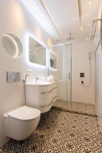 a bathroom with a toilet and a sink and a shower at Royal De Luxe Apartment in Michałowice