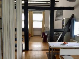 a view of a living room with a table at Suite „Friesland“ - wunderschönes Apartment in Fachwerkhaus in Hannover
