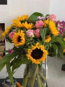 a glass vase filled with yellow and pink flowers at The Starry Rock in Kirriemuir