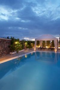 una piscina notturna con gazebo di Meli Meli a Imerovigli