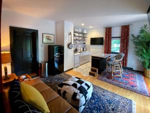 a living room with a couch and a kitchen at Addison Choate in Rockport