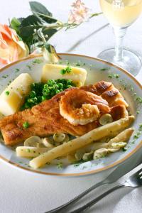 a plate of food with fish pasta and peas at Hotel Gran Corona in Sao Paulo