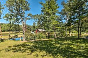 a yard with trees and a house in the background at Saylorsburg Retreat 16 Mi to Ski Resort in Saylorsburg