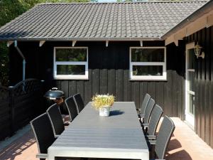 einen Tisch und Stühle vor einem Haus in der Unterkunft 8 person holiday home in Hadsund in Hadsund