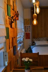 a bedroom with a wall covered in wood panels at Olimpijska kuca Jahorina - Apartman A708 in Jahorina