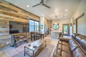 a living room with a leather couch and a table at Bozeman Stand-Alone Home with River Access! in Bozeman