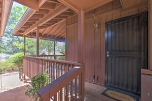a front porch of a house with a black door at Near Golfing and Hiking Payson Family Cabin! in Payson