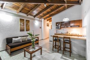 a kitchen and living room with a couch and a table at Cordillera Hotel in Trujillo