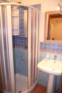 a bathroom with a shower and a sink at La Finestra Sotto La Rocca in Cefalù