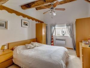 a bedroom with a bed and a ceiling fan at Holiday home with pool in Cuxac Cabard s in Cuxac-Cabardès