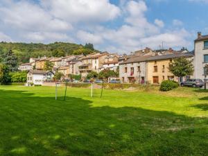 a grassy field with two goal posts in a city at Holiday home with pool in Cuxac Cabard s in Cuxac-Cabardès