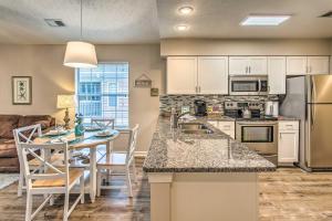 a kitchen and living room with a table and chairs at Chic Myrtle Beach Condo with Resort Amenity Access in Myrtle Beach