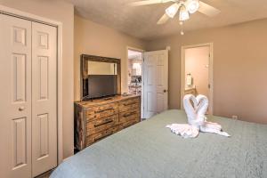 a bedroom with a bed and a mirror and a television at Chic Myrtle Beach Condo with Resort Amenity Access in Myrtle Beach