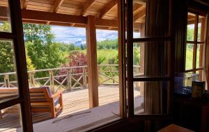 a screened in porch with a view of the woods at Fly Fishing Cabin, Great Views in Junín de los Andes