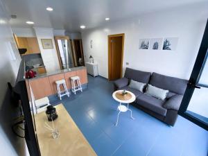 a living room with a couch and a table at Ventana al roque apartamento con vistas al mar in Santa Cruz de Tenerife