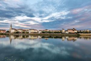 a view of a city with a large body of water at Hôtel du Nord, Sure Hotel Collection by Best Western in Mâcon