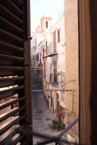 a view of an alley from a window at La Finestra Sotto La Rocca in Cefalù