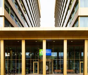 an office building with a sign in front of it at Holiday Inn Express Amsterdam - North Riverside by IHG in Amsterdam