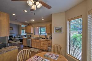 a kitchen with a table and a ceiling fan at Pet-Friendly Payson Cabin with Deck Close to Hikes! in Payson