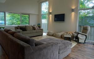 a living room with two couches and a tv at Baillieu Breeze in Point Lonsdale