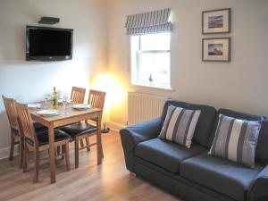 a living room with a couch and a table at Harbour Walk in Whitby