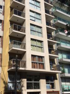a tall apartment building with balconies on it at Monoambiente En Arturo Prat in Montevideo