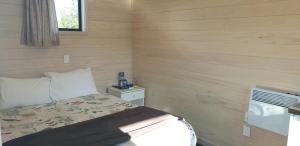 a small bedroom with a bed and a window at Tasman Holiday Parks - Christchurch in Christchurch