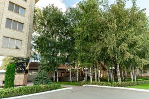 a group of trees in front of a building at Hotel Briz in Orenburg