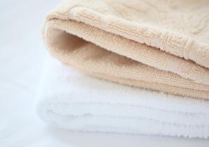 a stack of white towels on a white table at APA Hotel Marugame Ekimae Odori in Marugame +37 photos