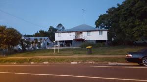 un coche aparcado frente a una casa blanca en Golden Mt Rest on James en Mount Morgan