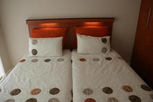 a bed with two pillows and a head board at B.R.O.Homes and Villas in Port Elizabeth