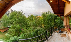 a balcony with a view of trees and bushes at Dragonfly Studio with GARDEN in Braşov