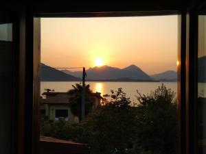 a view of a sunset from a window at Casa Bella Vista in Baveno