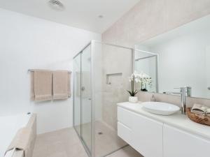 a white bathroom with a sink and a shower at Calm at Shoal Bay in Shoal Bay +19 photos