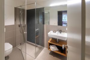 a bathroom with a shower and a sink at Brera Leipzig in Leipzig +18 photos
