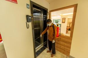 a man wearing a mask cleaning a glass door at The Green Boutique in Panaji