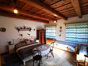 a bedroom with a bed and a table and chairs at Őrség Kincse in Hegyhátszentjakab