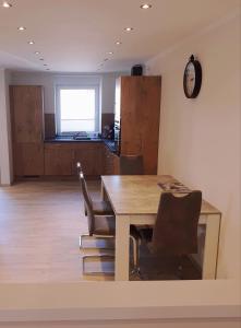 a dining room with a table and chairs at Ferienwohnung Valentin in Baustert +5 photos