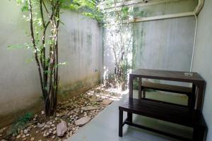 a room with a wooden table and a plant at S Hotel Kanchanaburi in Kanchanaburi