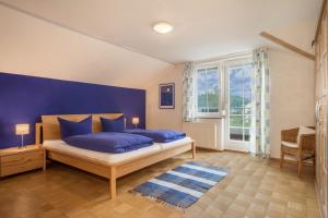 ein Schlafzimmer mit zwei blauen Kissen auf einem Bett in der Unterkunft Ferienwohnung Schleinseeblick in Kressbronn am Bodensee