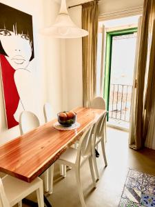 a dining room table with a bowl of fruit on it at Melodia3 Suites Noto in Noto