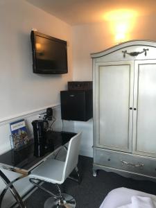 a room with a desk and a tv on the wall at Bawtrys in Bawtry