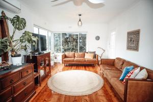 a living room with a couch and a tv at Craypot Cottage in Port Campbell