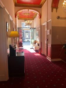 a hallway of a hotel with a red carpet at Atlas Guest House in Edinburgh