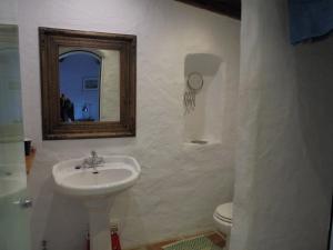 a bathroom with a sink and a toilet and a mirror at Beautiful Cortijo with pool near Ronda in Ronda +27 photos