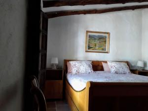 a bedroom with a bed and a picture on the wall at Beautiful Cortijo with pool near Ronda in Ronda