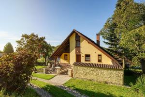 a house with a stone pathway leading to it at Chalupa pod Ještědem in Světlá pod Ještědem